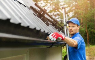 Man Cleaning Gutter