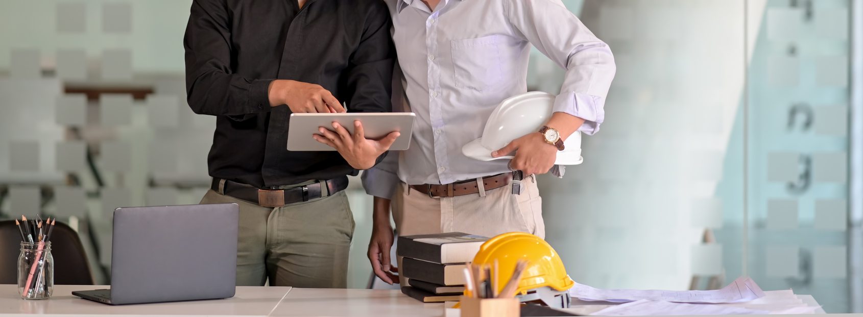 two businessmen discussing roof plans