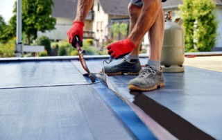 worker installing flat roof