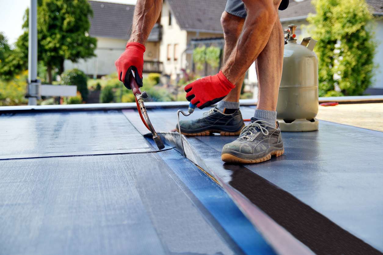 worker installing flat roof