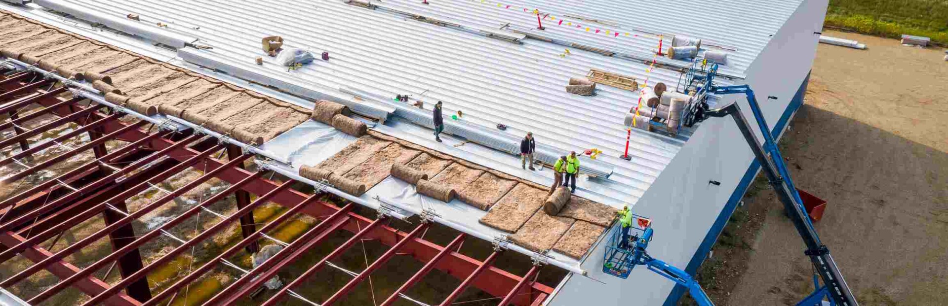 Roofers working on commercial roof installation
