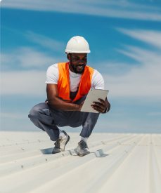 cost-transparency-photo Roofing professional reviewing project information on a tablet