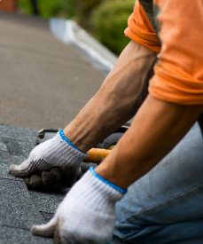workmanship-warranty-photo Roofing installer placing shingles by hand